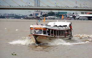An Orange Line Chao Phraya Express Boat approaching Phra Arthit Pier in Banglamphu District of Bangkok