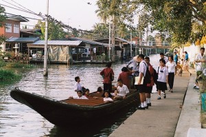 These children are boarding a boat to take them home from school. This is in the Thonburi side of Bangkok, on Klong Bangmod.
