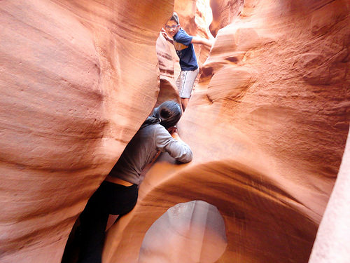 Family Fun in the slot of Peek-A-Boo Gulch in the Dry Fork of Coyote Gulch in Grand Staircase Escalante National Monument in Utah