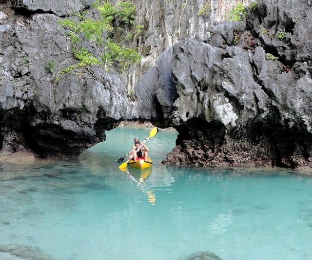 Kayak exiting Small Lagoon, Miniloc Island, Bacuit Bay, El Nido, Palawan, Philippines