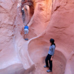 Tra la seconda e la terza pozza Between the second and the third pothole of Peek-A-Boo Slot Canyon, the Dry Fork of Coyote Gulch in Grand Staircase Escalante NM in Utah USA