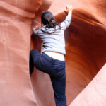 E’ l’ultimo passaggio… Climbing the small arch in Peek-A-Boo Slot Canyon the Dry Fork of Coyote Gulch in Grand Staircase Escalante NM in Utah USA