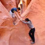 All’attacco della terza pozza Climbing the third pothole of Peek-A-Boo Slot Canyon the Dry Fork of Coyote Gulch in Grand Staircase Escalante NM in Utah USA