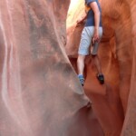 Se i grandi scelgono la strada più facile… Kid plays into the slot of Peek-A-Boo Gulch in the Dry Fork of Coyote Gulch in Grand Staircase Escalante NM in Utah USA
