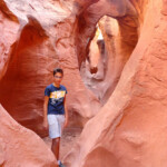 Qualcuno è già in cima alla terza pozza… Near the double arch of Peek-A-Boo Slot Canyon the Dry Fork of Coyote Gulch in Grand Staircase Escalante NM in Utah USA