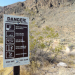 Non entrare mai in una miniera abbandonata... Danger abandoned mine hazards sign at Leadfield Ghost Town in Death Valley National Park California
